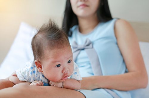 newborn baby on mother's lap